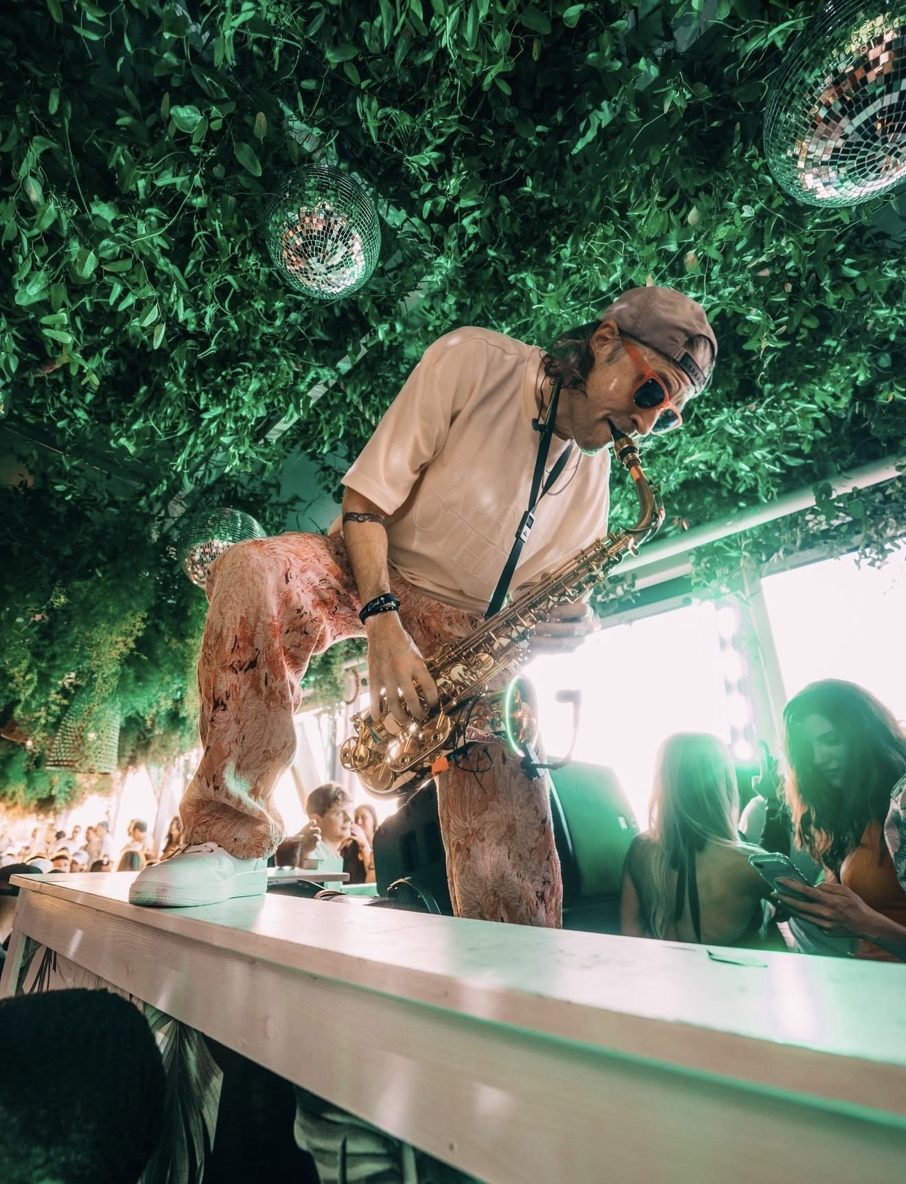 Palm Tree Club Miami saxophonist live entertainment green canopy disco balls