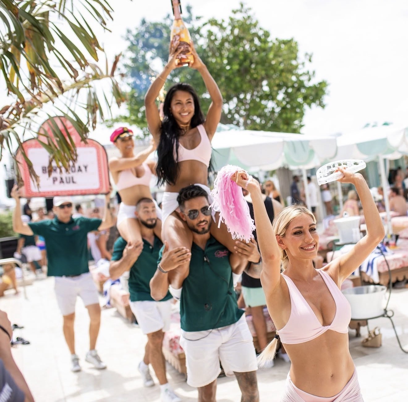 Strawberry Moon Miami Beach VIP birthday bottle parade staff carrying guest champagne pink sign