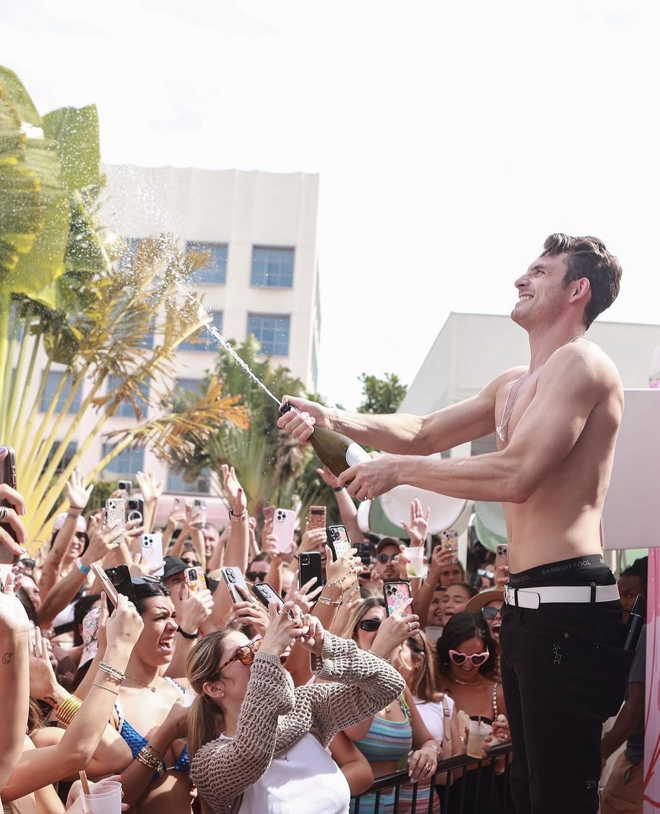 Strawberry Moon Miami Beach pool party champagne spray performer stage packed crowd pink building
