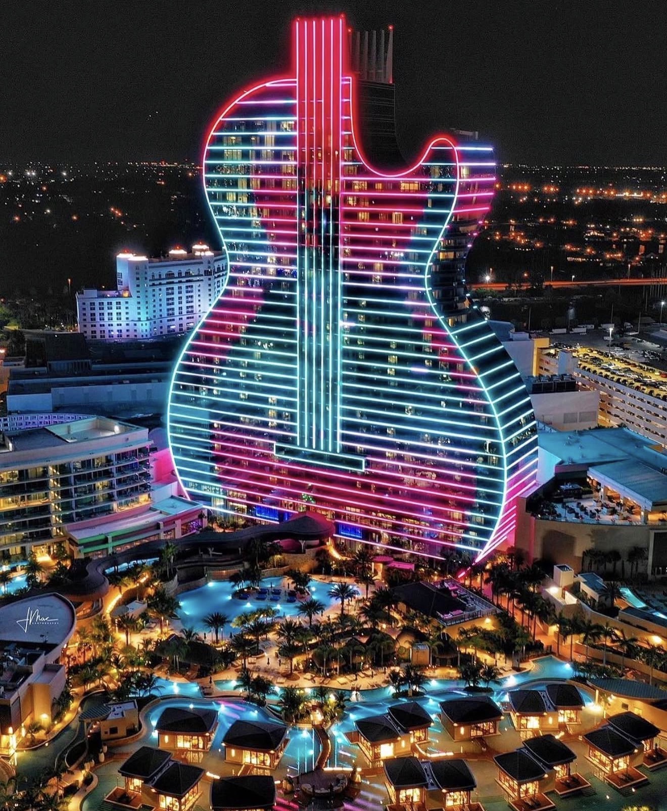 Daer Dayclub Seminole Hard Rock Hotel guitar shaped building neon lights aerial night view pool complex Hollywood Florida